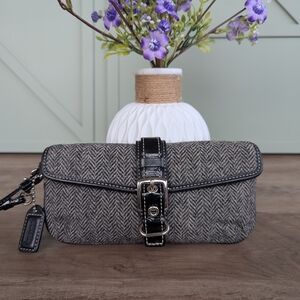 Coach Herringbone Wool Buckle Wristlet, also frequently referred to as a clutch